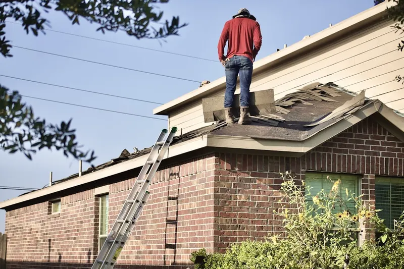 Professional roofer working on a residential roof in Platteville